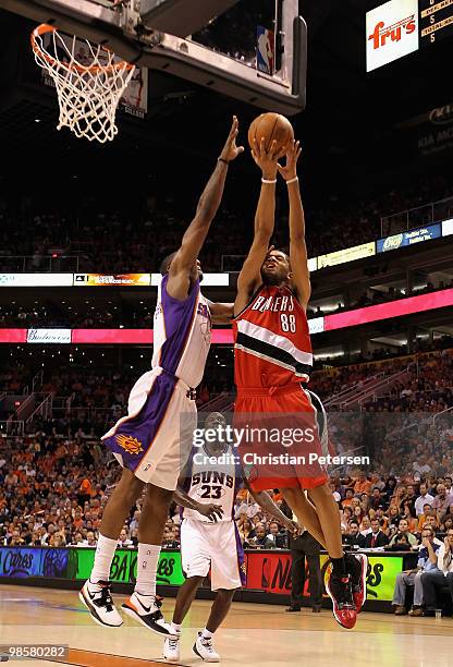 Nicolas Batum of the Portland Trail Blazers is fouled by Amar'e Stoudemire of the Phoenix Suns as he attempts a shot during Game Two of the Western...