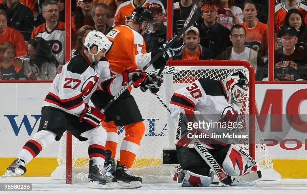 Martin Brodeur of the New Jersey Devils surrenders a third period goal to Daniel Carcillo of the Philadelphia Flyers as Mike Mottau defends against...