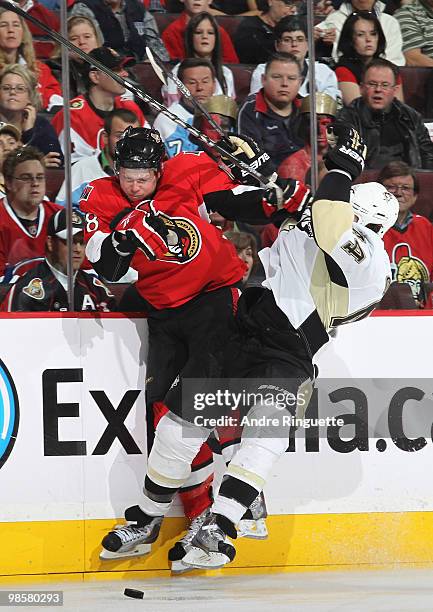 Jesse Winchester of the Ottawa Senators and Brooks Orpik of the Pittsburgh Penguins collide along the boards in Game Four of the Eastern Conference...