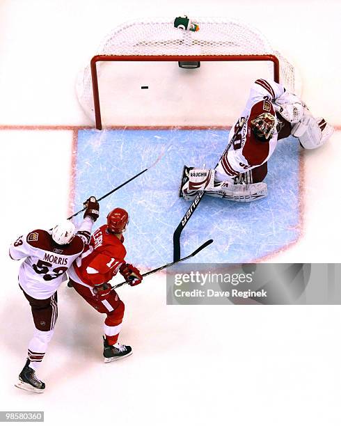 Pavel Datsyuk of the Detroit Red Wings scores as teammate Dan Cleary gets tied up by Derek Morris of the Phoenix Coyotes during Game Four of the...