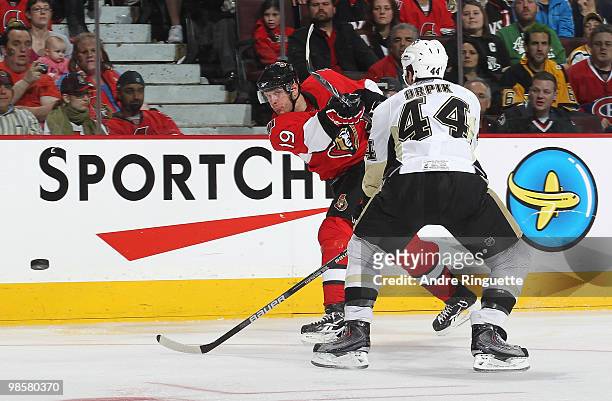 Jason Spezza of the Ottawa Senators shoots the puck against Brooks Orpik of the Pittsburgh Penguins in Game Four of the Eastern Conference...