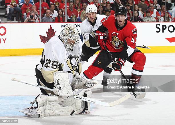Peter Regin of the Ottawa Senators crashes the net with Jordan Staal of the Pittsburgh Penguins following as Marc-Andre Fleury makes a save in Game...