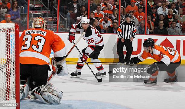 Brian Boucher and Matt Carle of the Philadelphia Flyers defend against Patrik Elias of the New Jersey Devils in Game Four of the Eastern Conference...