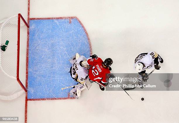 Mike Fisher of the Ottawa Senators tries to deflect a point shot out front of Marc-Andre Fleury of the Pittsburgh Penguins in Game 4 of the Eastern...