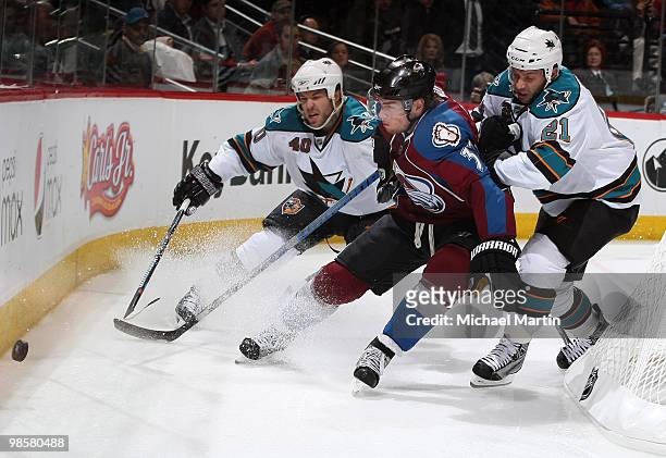 Ryan O'Reilly of the Colorado Avalanche skates against Scott Nichol and Kent Huskins of the San Jose Sharks in Game Four of the Western Conference...