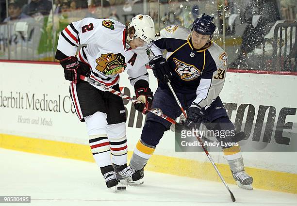 Colin Wilson of the Nashville Predators and Duncan Keith of the Chicago Blackhawks battle for the puck during game 3 of the Western Conference...