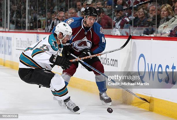 John-Michael Liles of the Colorado Avalanche skates against Torrey Mitchell of the San Jose Sharks in Game Four of the Western Conference...