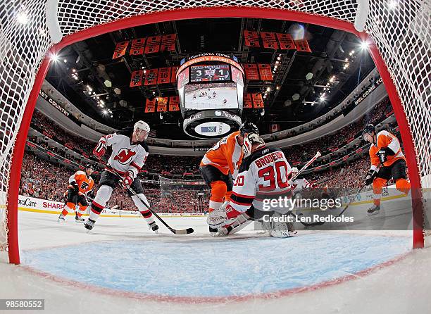 Martin Brodeur and Colin White of the New Jersey Devils defend against the attack of Jeff Carter and Danny Briere of the Philadelphia Flyers in Game...