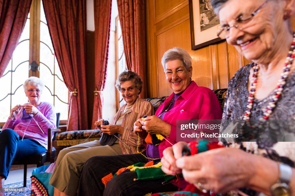 Cheerful candid portrait of senior women knitting