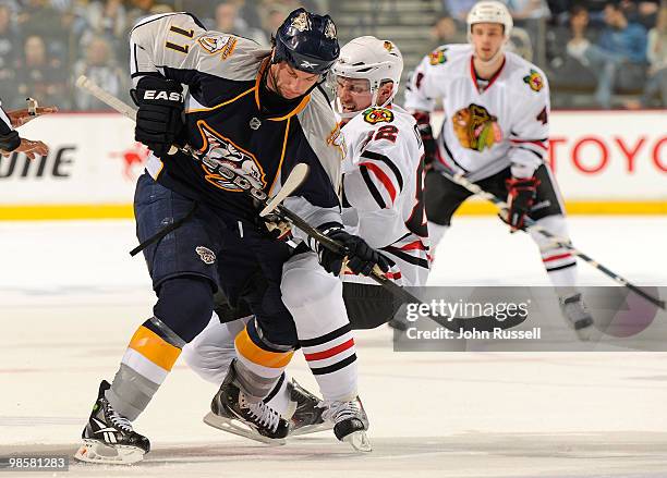 David Legwand of the Nashville Predators is tied up by Tomas Kopecky the Chicago Blackhawks in Game Three of the Western Conference Quarterfinals...