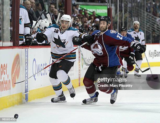 Kyle Quincey of the Colorado Avalanche and Devin Setoguchi of the San Jose Sharks chase after a loose puck along the boards in the second period of...