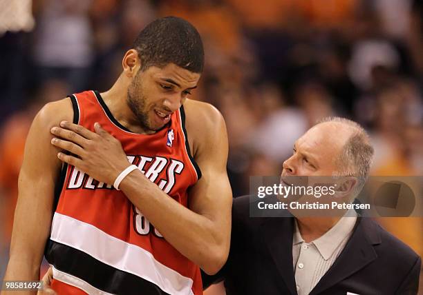 Nicolas Batum of the Portland Trail Blazers walks off the court with athletic trainer Jay Jensen after an injury during Game Two of the Western...