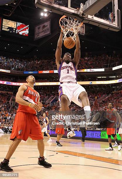 Amar'e Stoudemire of the Phoenix Suns slam dunks the ball over Juwan Howard of the Portland Trail Blazers during Game Two of the Western Conference...