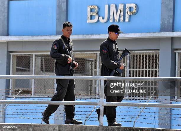 Security personnel of the Bureau of Jail Management and Penology, patrol the perimeter of the maximum prison building where members of the Muslim...