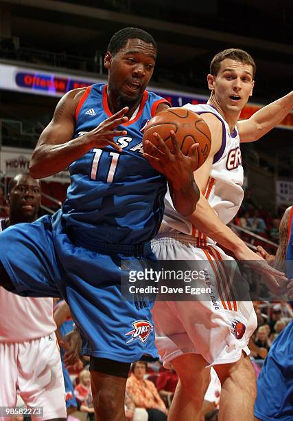 Cecil Brown of the Tulsa 66ers battles for a loose ball with Connor Atchley of the Iowa Energy in the first half of Game Three of their semi-final...
