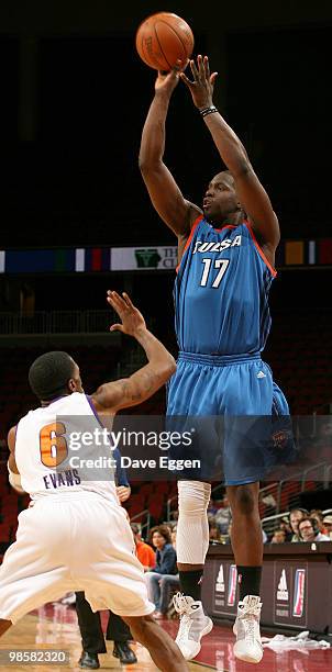 Moses Ehambe of the Tulsa 66ers shoots over Brian Evans of the Iowa Energy in the first half of Game Three of their semi-final round series in the...