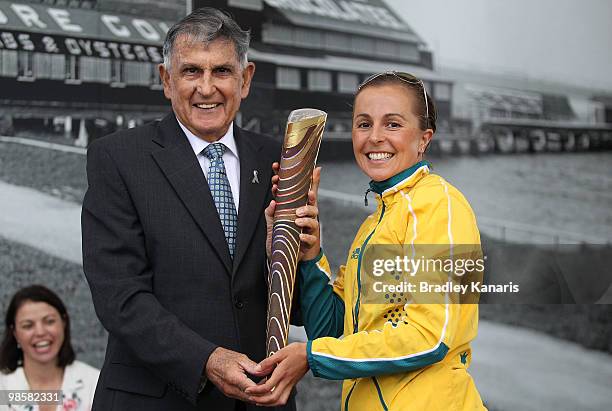 Triathlon champion Emma Snowsill of Australia hands over the Queens Baton to Gold Coast Lord Mayor Ron Clarke as part of the Delhi 2010 Commonwealth...