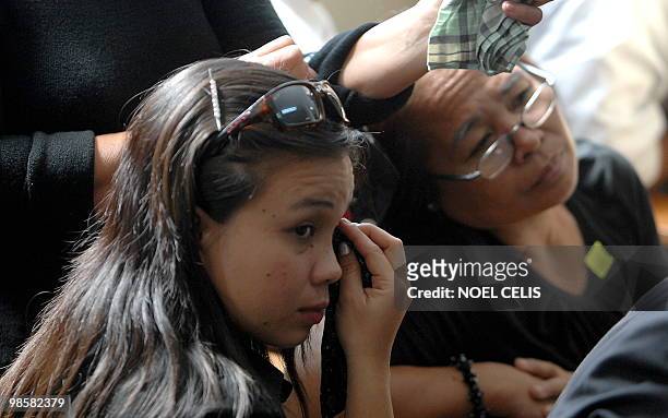 Relative of a Maguindanao massacre victim wipes tears during the preliminary hearing of the murder case at Camp Bagong Diwa in suburb of Manila on...