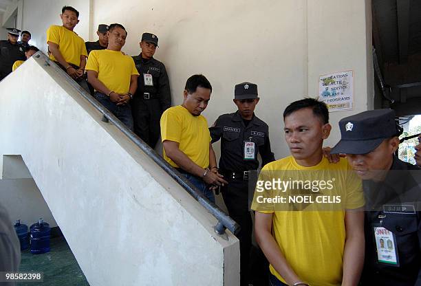 Maguindanao massacre suspects composing of nine police officers and two members of the Civilian Volunteers Organization are escorted by policemen to...