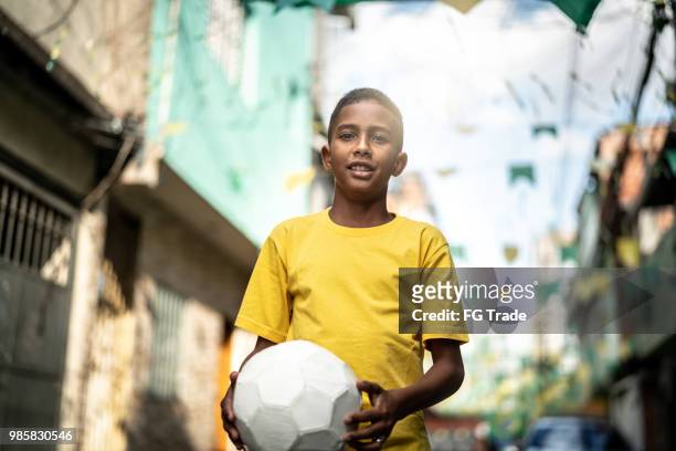 brazilian kid playing soccer portrait - the project portraits stock pictures, royalty-free photos & images