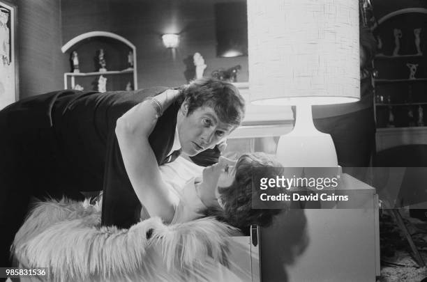 English actor, comedian, philanthropist, and singer Michael Crawford with British actress Paddy Webster filming a scene of British sports drama film...