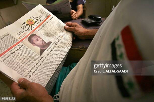 An Iraqi man reads an article picturing a man authorities claim is Abu Omar al-Baghdadi, said to be the leader of the Al-Qaeda umbrella group in...