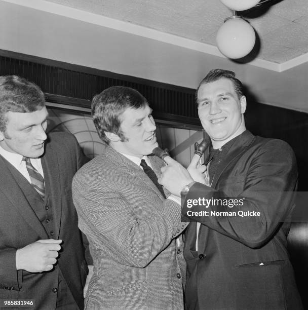 British heavyweights boxers Billy Walker, Joe Bugner, and Jack Bodell celebrating the birth of Walker's son Daniel, UK, 7th March 1969.