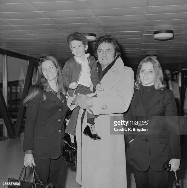 American musician and singer Johnny Cash pictured with his wife June Carter Cash , son John Carter Cash and daughter Cindy Cash at Heathrow airport...