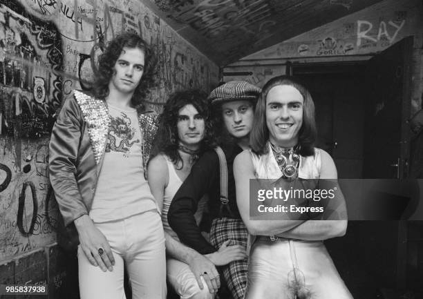 English rock and pop group Slade posed together backstage at a venue in the United Kingdom on 6th September 1972. The band are, from left, bassist...