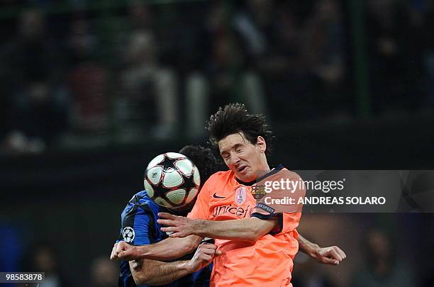 Barcelona's Argentinian forward Lionel Messi jumps for the ball against Inter Milan's Serbian midfielder Dejan Stankovic during the UEFA Champions...