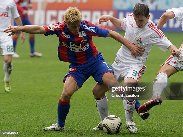 Keisuke Honda of PFC CSKA Moscow battles for the ball with Oleg Kuzmin of FC Lokomotiv Moscow during the Russian Football League Championship match...