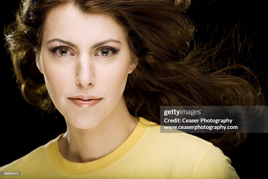 Pretty brunette woman in yellow shirt