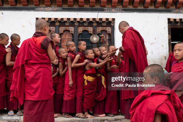 Bhutanese monks line up for juice and biscuits at the Dechen Phodrang monastery on June 14 in Thimphu, Bhutan. Around 250 monks reside at the...
