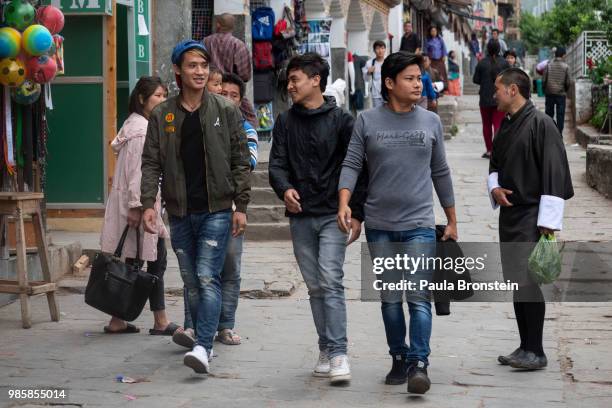 Bhutanese youth are seen walking in central Thimphu on June 14 in Thimphu, Bhutan. While many are expected to wear the "Gho" which is the traditional...