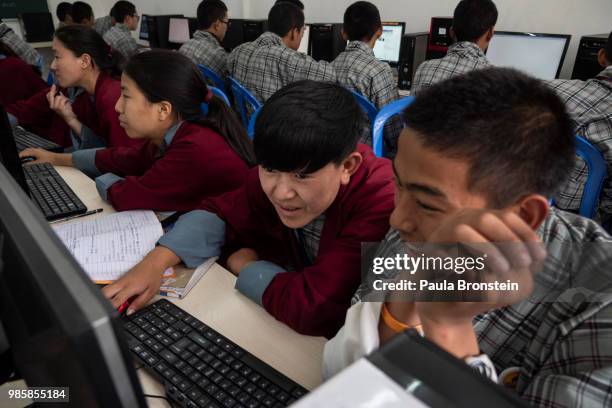 Tashi Dema, 17 and Wangchuk Dema 16, work in a large computer lab at the Pelkhil high school on June 15, in Thimphu, Bhutan. The school teaches many...