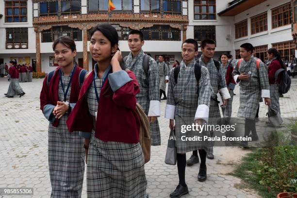 Bhutanese students walk home from the Pelkhil high school wearing their traditional Bhutanese uniform that is required for all students on June 15,...