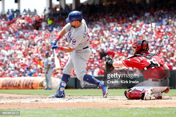 Tucker Barnhart of the Cincinnati Reds prepares to catch the ball as Kyle Schwarber of the Chicago Cubs takes an at bat during the game at Great...