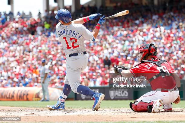 Tucker Barnhart of the Cincinnati Reds catches the ball as Kyle Schwarber of the Chicago Cubs takes an at bat during the game at Great American Ball...