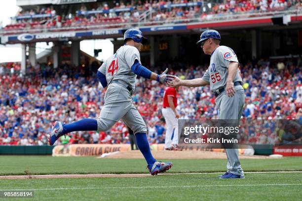 Anthony Rizzo of the Chicago Cubs is congratulated by third base coach Brian Butterfield after hitting a home run during the game against the...