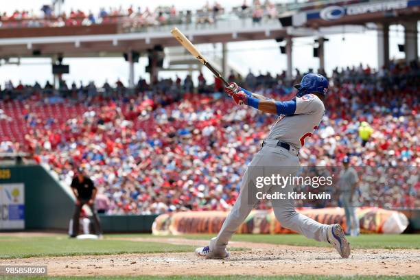 Addison Russell of the Chicago Cubs hits the ball during the game against the Cincinnati Reds at Great American Ball Park on June 24, 2018 in...