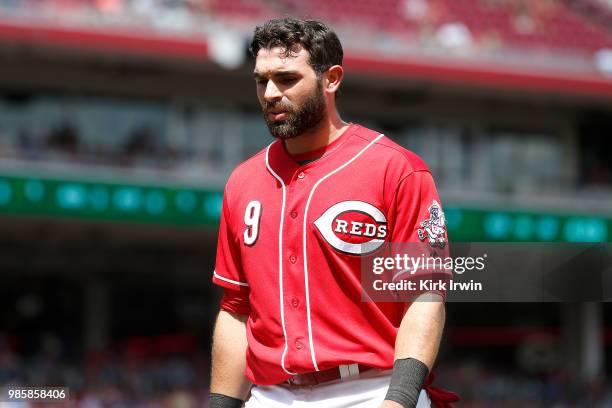 Jose Peraza of the Cincinnati Reds walks off of the field during the game against the Chicago Cubs at Great American Ball Park on June 24, 2018 in...