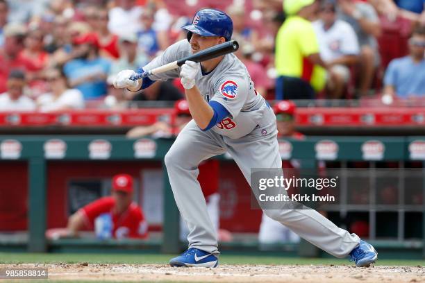Mike Montgomery of the Chicago Cubs attempts to bunt the ball during the game against the Cincinnati Reds at Great American Ball Park on June 24,...