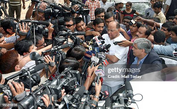 Indian Minister of Agriculture Sharad Pawar addresses the media as Board of Control for Cricket in India chief Shashank Manohar looks on at Pawar's...