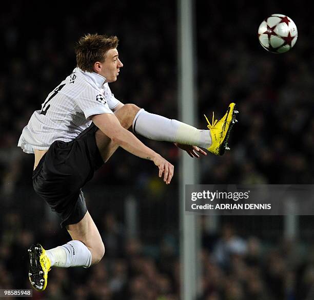 Arsenal's Danish player Niklas Bendtner jumps for the ball against Barcelona during the Champions League quarter-final second-leg match at Camp Nou...