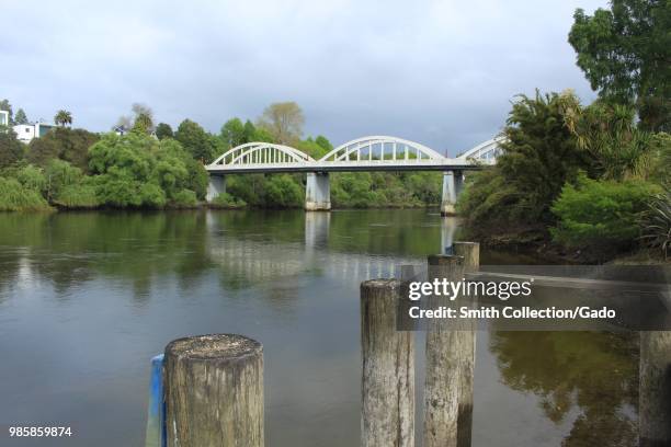 Iconic Fairfield Bridge crossing the Waikato River with pilings in the foreground, Hamilton, New Zealand, November, 2017.