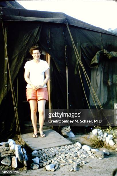 Portrait of Laura Wilson, of the neurosurgical team at the 8063rd MASH , as she stands in the doorway of a tent, South Korea, January 1952.