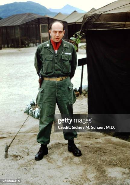 Portrait of American military surgeon Captain Sidney Schaer , of the 8063rd MASH , as he poses, hands behind his back, outside a tent, South Korea,...