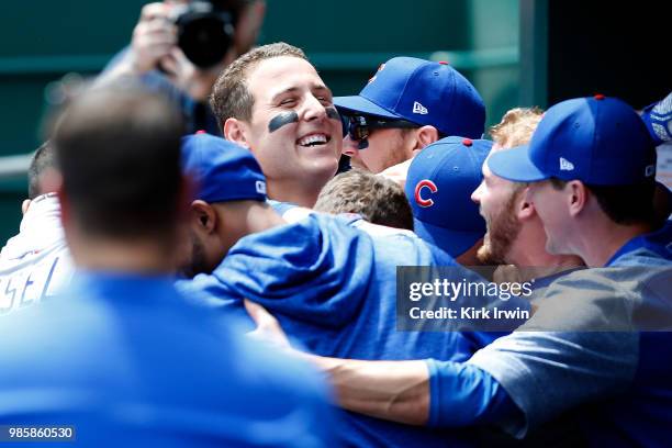 Anthony Rizzo of the Chicago Cubs is congratulated by his teammates after hitting a home run during the game against the Cincinnati Reds at Great...