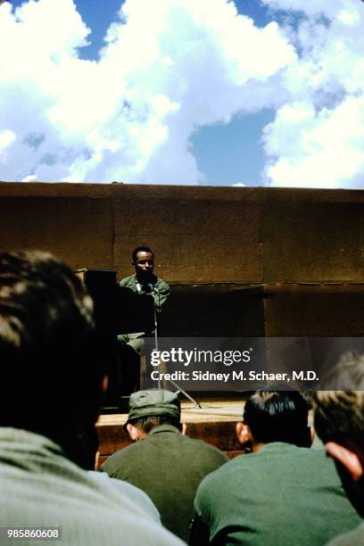 An unidentified musician plays piano as he performs onstage for troops at the 8063rd MASH , South Korea, January 1952.