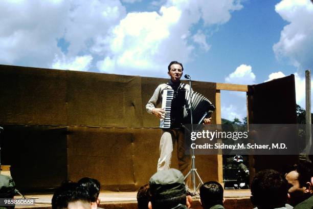 An unidentified musician plays accordion as he performs onstage at the 8063rd MASH , South Korea, January 1952.